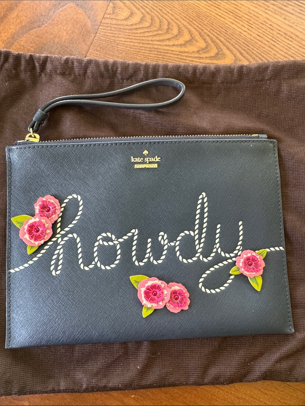 kate spade black wristlet with floral appliqué and 'howdy' script